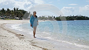 Young girl walks along the beach.