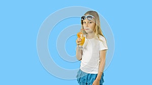 A young girl walks by drinking juice and waving her hand. Clip with transparent alpha channel.