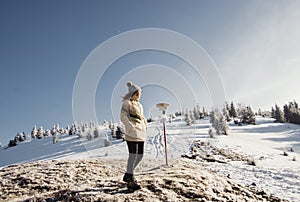 Young girl in warm clothes went camping in the mountains