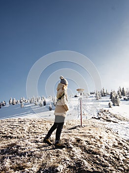 Young girl in warm clothes went camping in the mountains