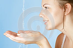 Young girl washes with clean water photo