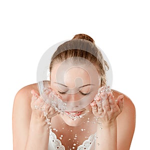 Young girl washes with clean water photo