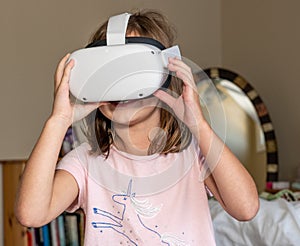 Young girl watching an app on a modern VR headset