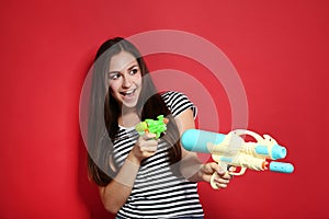 Young girl with water guns