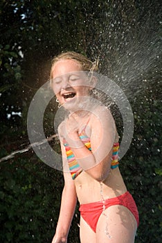 Young girl in water jet