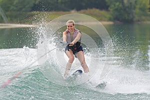 Young girl water skiing on slalom course