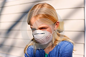 Young girl wearing anti viral face mask