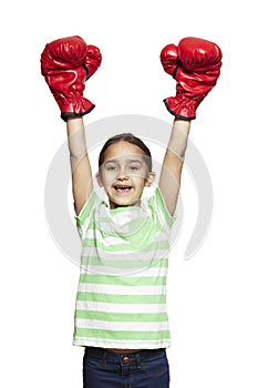Young girl wearing boxing gloves smiling
