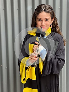 Young girl wearing a costume of young wizard scholar