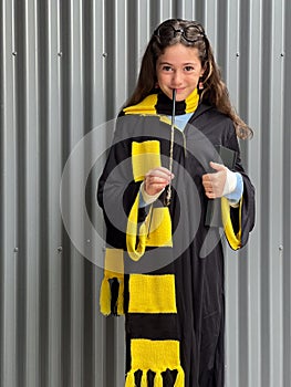 Young girl wearing a costume of young wizard scholar