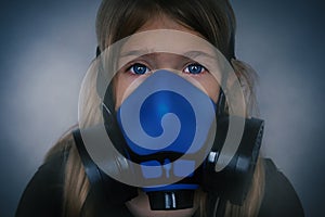 Young girl wearing gasmask, respirator portrait