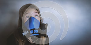 Young girl wearing gasmask, respirator portrait