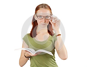 Young girl wearing glasses holding textbook.
