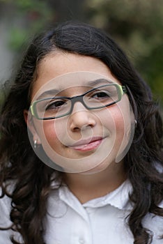 Young girl wearing green glasses smiling