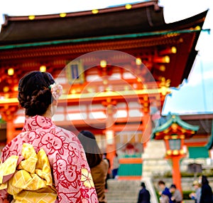 Young girl wearing Japanese kimono standing in front of japanese