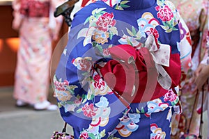 Young girl wearing Japanese kimono standing in front of Sensoji