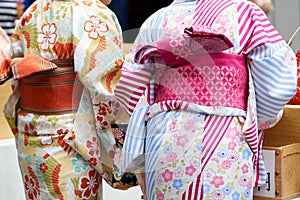 Young girl wearing Japanese kimono standing in front of Sensoji