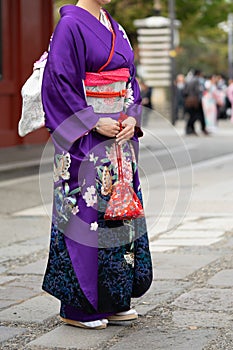 Young girl wearing Japanese kimono standing in front of Sensoji