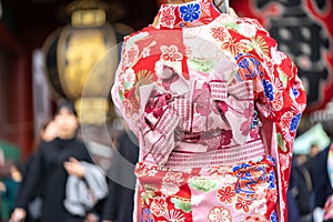 Young girl wearing Japanese kimono standing in front of Sensoji