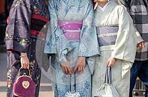 Young girl wearing Japanese kimono standing in front of Sensoji Temple in Tokyo, Japan.