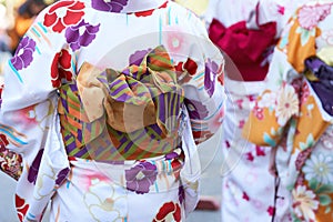 Young girl wearing Japanese kimono standing in front of Sensoji Temple in Tokyo, Japan. Kimono is a Japanese traditional garment.