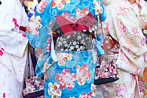 Young girl wearing Japanese kimono standing in front of Sensoji Temple in Tokyo, Japan. Kimono is a Japanese traditional garment.