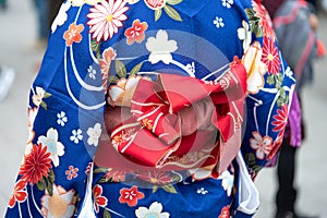 Young girl wearing Japanese kimono standing in front of Sensoji Temple in Tokyo, Japan. Kimono is a Japanese traditional garment.