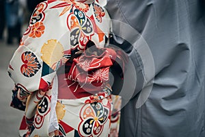 Young girl wearing Japanese kimono standing in front of Sensoji Temple in Tokyo, Japan. Kimono is a Japanese traditional garment.