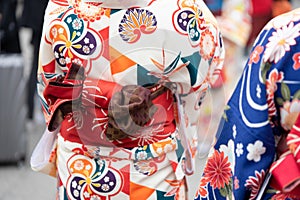 Young girl wearing Japanese kimono standing in front of Sensoji Temple in Tokyo, Japan. Kimono is a Japanese traditional garment.