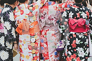 Young girl wearing Japanese kimono standing in front of Sensoji Temple in Tokyo, Japan. Kimono is a Japanese traditional garment.