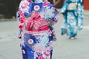 Young girl wearing Japanese kimono standing in front of Sensoji Temple in Tokyo, Japan. Kimono is a Japanese traditional garment.