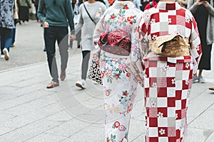 Young girl wearing Japanese kimono standing in front of Sensoji Temple in Tokyo, Japan. Kimono is a Japanese traditional garment.