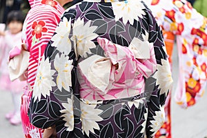 Young girl wearing Japanese kimono standing in front of Sensoji Temple in Tokyo, Japan. Kimono is a Japanese traditional garment.