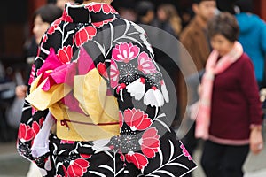 Young girl wearing Japanese kimono standing in front of Sensoji Temple in Tokyo, Japan. Kimono is a Japanese traditional garment.