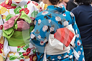 Young girl wearing Japanese kimono standing in front of Sensoji Temple in Tokyo, Japan. Kimono is a Japanese traditional garment.