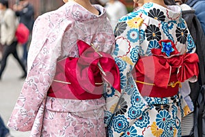 Young girl wearing Japanese kimono standing in front of Sensoji Temple in Tokyo, Japan. Kimono is a Japanese traditional garment.