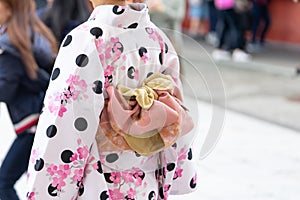 Young girl wearing Japanese kimono standing in front of Sensoji Temple in Tokyo, Japan. Kimono is a Japanese traditional garment.