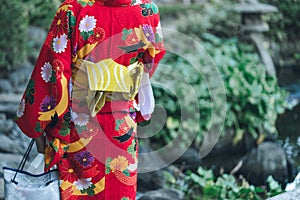 Young girl wearing Japanese kimono standing in front of Sensoji Temple in Tokyo, Japan. Kimono is a Japanese traditional garment.