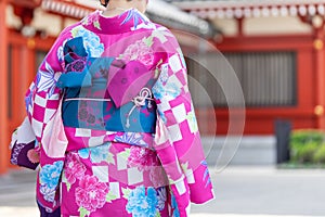 Young girl wearing Japanese kimono standing in front of Sensoji Temple in Tokyo, Japan. Kimono is a Japanese traditional garment.