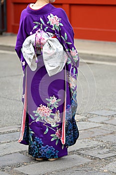 Young girl wearing Japanese kimono standing in front of Sensoji Temple in Tokyo, Japan. Kimono is a Japanese traditional garment.