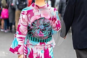 Young girl wearing Japanese kimono standing in front of Sensoji Temple in Tokyo, Japan. Kimono is a Japanese traditional garment.