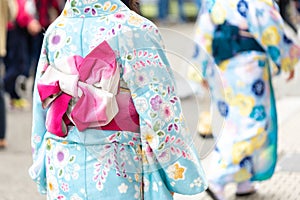 Young girl wearing Japanese kimono standing in front of Sensoji Temple in Tokyo, Japan. Kimono is a Japanese traditional garment.