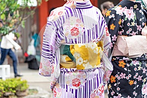 Young girl wearing Japanese kimono standing in front of Sensoji Temple in Tokyo, Japan. Kimono is a Japanese traditional garment.