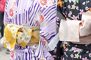 Young girl wearing Japanese kimono standing in front of Sensoji Temple in Tokyo, Japan. Kimono is a Japanese traditional garment.