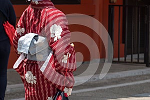 Young girl wearing Japanese kimono standing in front of Sensoji Temple in Tokyo, Japan. Kimono is a Japanese traditional garment.