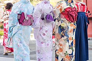 Young girl wearing Japanese kimono standing in front of Sensoji Temple in Tokyo, Japan. Kimono is a Japanese traditional garment.