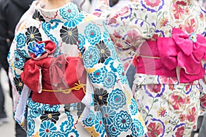 Young girl wearing Japanese kimono standing in front of Sensoji Temple in Tokyo, Japan. Kimono is a Japanese traditional garment.