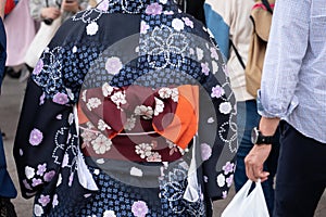 Young girl wearing Japanese kimono standing in front of Sensoji Temple in Tokyo, Japan. Kimono is a Japanese traditional garment.