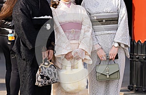 Young girl wearing Japanese kimono standing in front of Sensoji Temple in Tokyo, Japan.