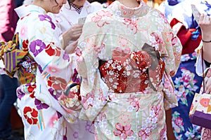 Young girl wearing Japanese kimono standing in front of Sensoji Temple in Tokyo, Japan. Kimono is a Japanese traditional garment.